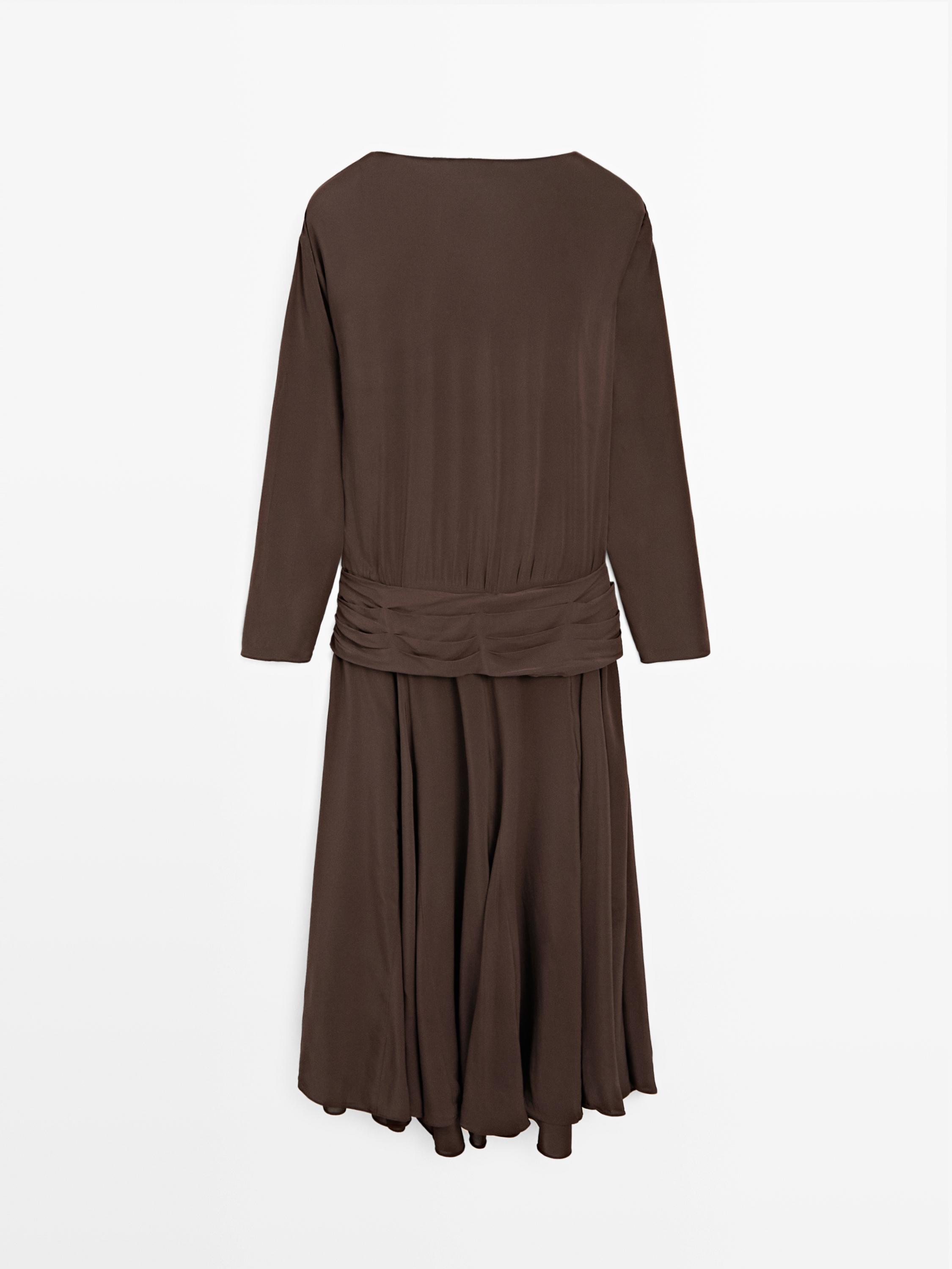 Long flowing dress with draped sash belt